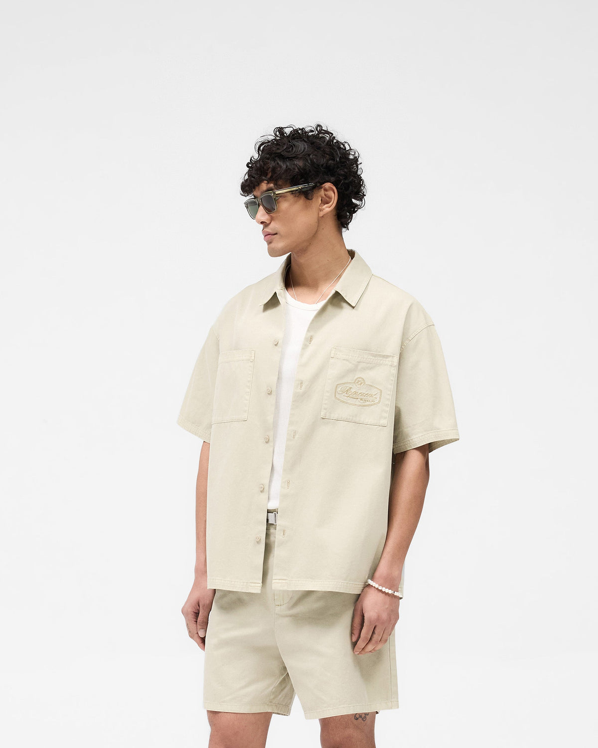 0143__0018_022125_SS25DROP2_SHORTSLEEVECOTTONOVERSHIRT_BEIGE_1_ea1dd331-5d09-4735-9b08-a4540a6adfef